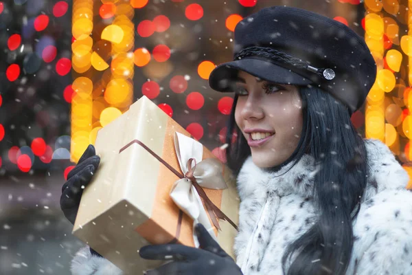 Fashionable Young Woman Receiving Gift Holiday Fair Snowfall Empty Space — Stock Photo, Image