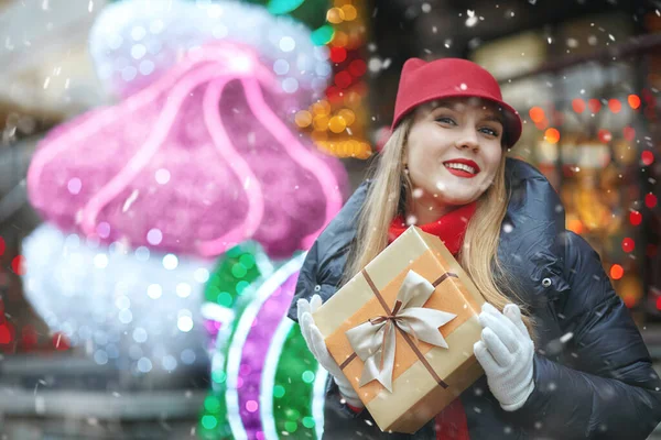 Cheerful Blond Woman Gift Box Street Christmas Market Snowfall Empty — Stock Photo, Image