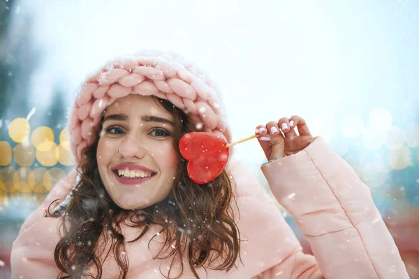 Веселая Брюнетка Розовой Шляпе Кусающая Сладкие Красные Конфеты Форме Сердца — стоковое фото