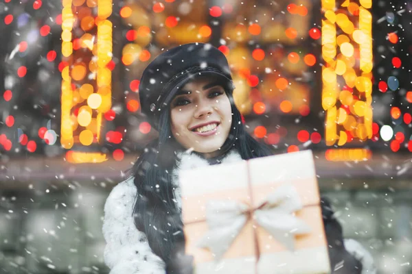 Joyful Young Woman Receiving Gift Holiday Fair Snowfall Empty Space — Stock Photo, Image