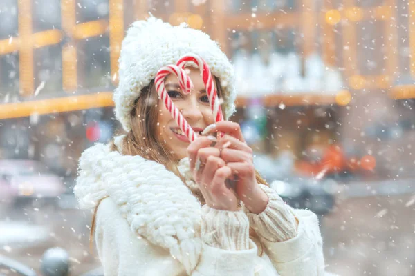 Radosna Blondynka Trzymająca Cukierki Świątecznych Targach Zimowych Podczas Opadów Śniegu — Zdjęcie stockowe