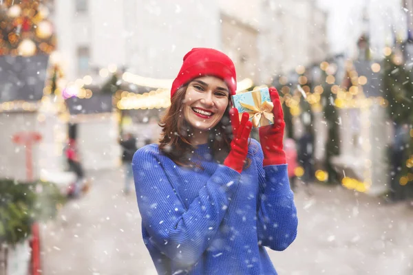 Cheerful Young Woman Holding Gift Box Ribbon Christmas Fair Empty — 图库照片
