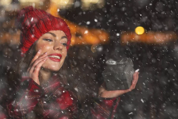 Lovely Young Woman Receiving Gift Christmas Market Snowfall Space Text — Stock Photo, Image