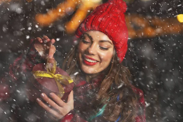 Charming Young Woman Receiving Gift Christmas Market Snowfall Space Text — Stock Photo, Image