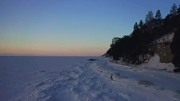 Αεροφωτογραφία. Το σούρουπο ήρθε σε παγωμένη λίμνη. Κάμπινγκ σε σοβαρή χειμερινή φύση — Αρχείο Βίντεο