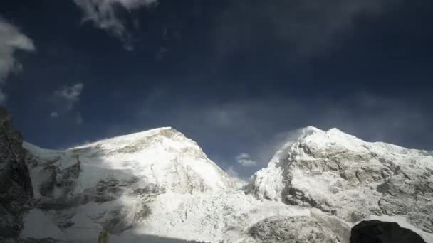 Nádherná doba, co uplynula. Chaotické mraky víří na modré obloze nad vrcholkem sněhových hor — Stock video