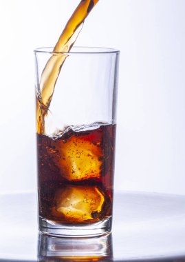 Buzlu bir bardak kola ve bir damla su.