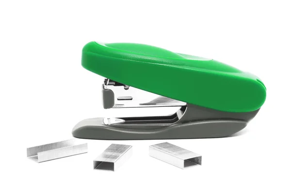 Green stapler on a white background with brackets — Stock Photo, Image