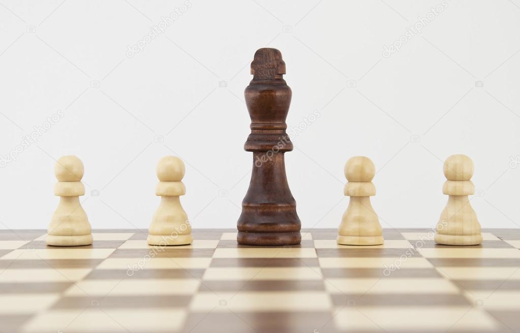 Chess king and pawns on chessboard