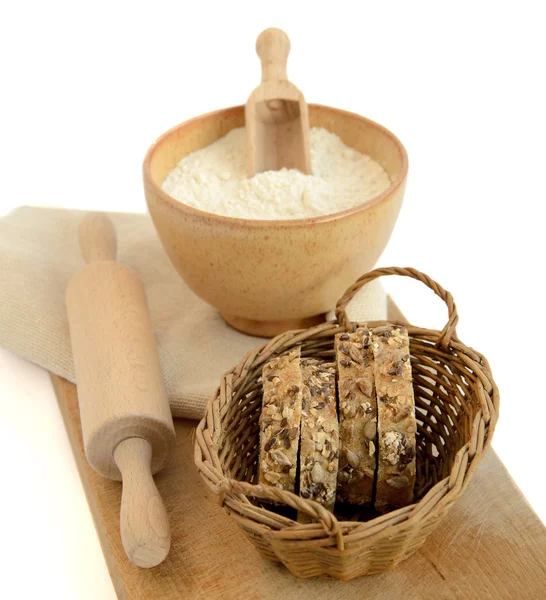 Slices of grain bread, flour and rolling pin — Stock Photo, Image