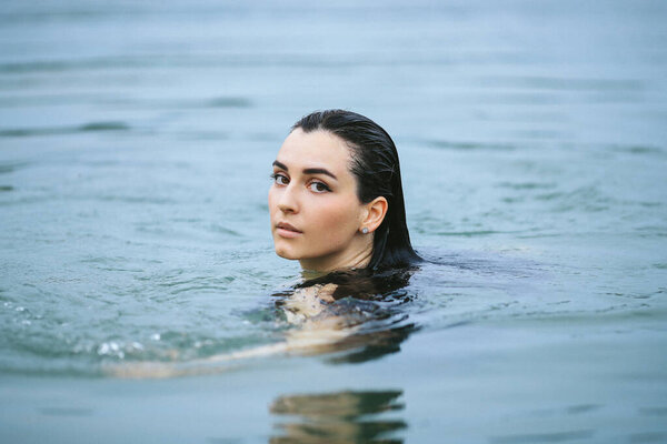 Beautiful woman swimming in lake