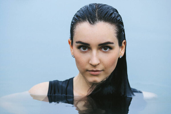 Beautiful woman swimming in lake