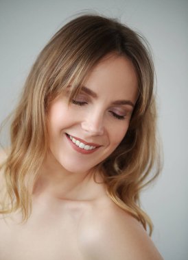 Portrait of beautiful lovely woman with wide smile on white backlground 