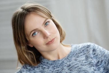 Portrait of young beautiful woman posing at cozy home