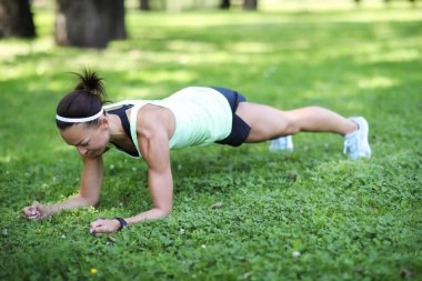Portrait of sporty young woman work out in the park in the morning