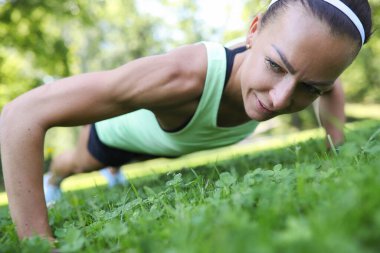 Portrait of sporty young woman work out in the park in the morning