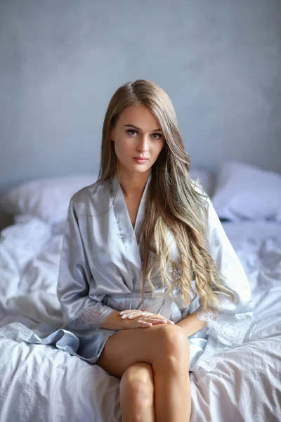 Attractive Sexy Young Blonde Woman Silver Nightgown Sitting Bed — ストック写真