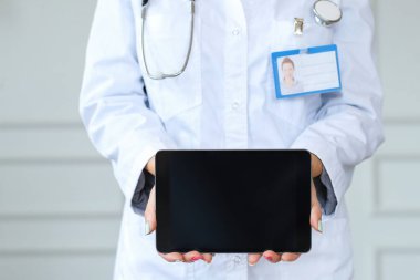 Woman doctor using digital tablet at work. Hospital and medicine concept