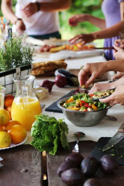 People preparing food for picnic