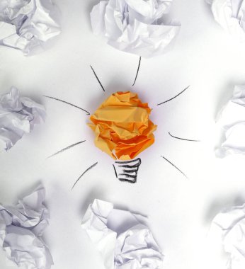 Crumpled paper with light bulb drawning on a white background