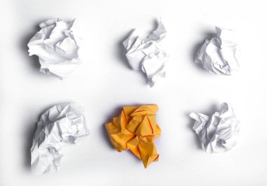 White and orange crumpled paper on a white background