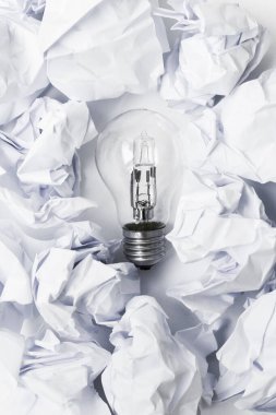 Crumpled paper with light bulb on a white background