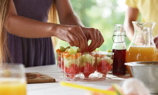 Female Hands Making Fruit Salad Portions — Zdjęcie stockowe