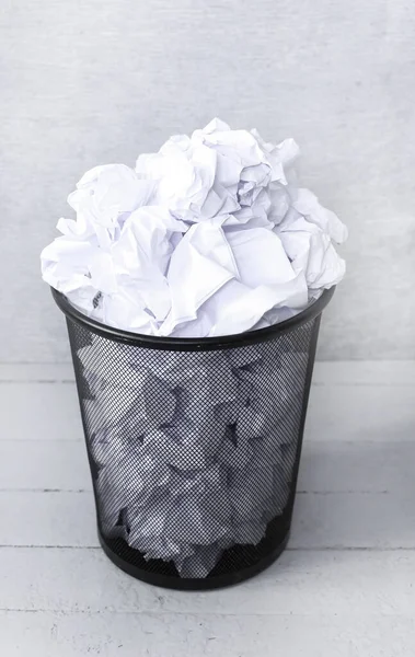 Crumpled paper in the trash can