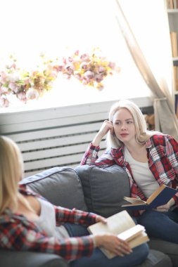 tender image of mother and daughter posing at home