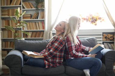 tender image of mother and daughter posing at home