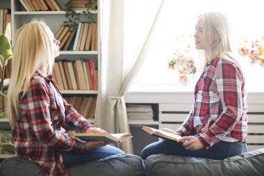 tender image of mother and daughter posing at home