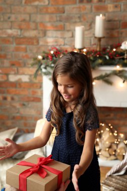 Lovely girl with gift box at Christmas Eve