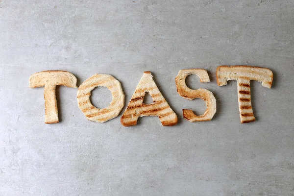 Λέξη Φτιαγμένη Από Ψωμί Στο Τραπέζι — Φωτογραφία Αρχείου