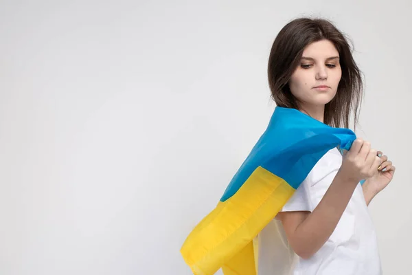 Woman Holds Ukrainian Blue Yellow Flag White Background Copy Space — стоковое фото