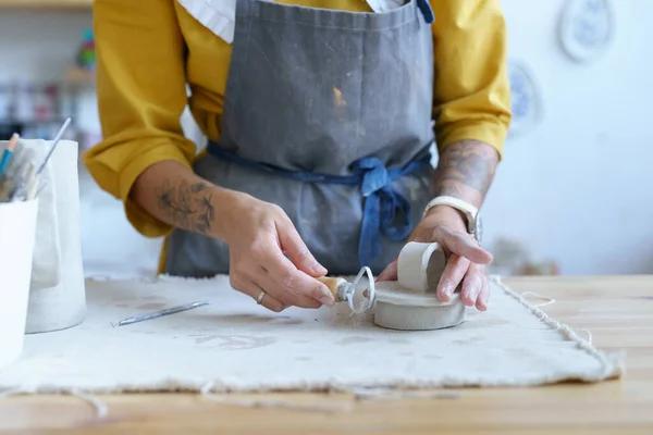 Жінка-художниця працює з сирою глиною в керамічній студії. Молода студентка готує матеріал для формування — стокове фото