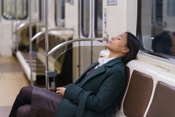 Tired african businesswoman sleep in subway carriage riding late from work overworked and exhausted — Stock Photo, Image