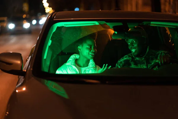 Happy couple in love talk inside car. Man and woman romantic lovers communicate at night after date — Fotografia de Stock