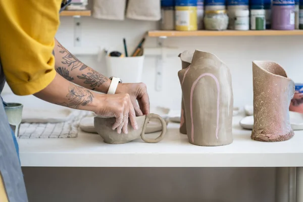 Female ceramist making mug in studio, woman working with clay during pottery masterclass — Stockfoto