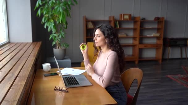 Young businesswoman or remote manager sit at desk exercising with rubber expander working at laptop — Wideo stockowe