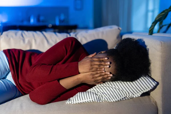 Depressziós afrikai nő fekszik a kanapén egyedül sír otthon, szenved a rossz mérgező kapcsolat — Stock Fotó