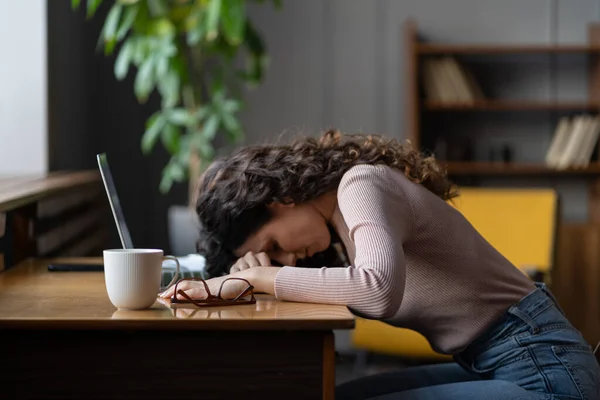 Overworked tired female freelancer or remote worker sleep on desk with laptop suffer from fatigue — Stock Photo, Image