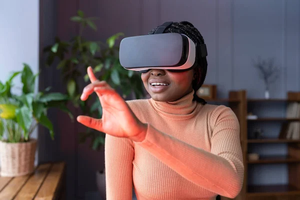 Afro woman enjoy vr gaming using virtual reality interface for shopping or game wear goggles at home — Stock Photo, Image