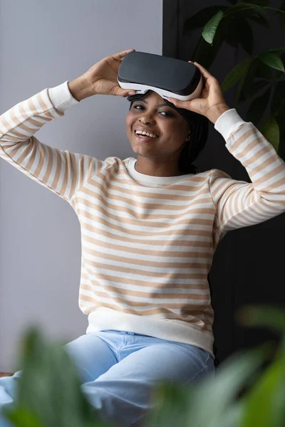 Happy african female hold vr headset for simulation in augmented reality test modern gadget at home — Stock Photo, Image