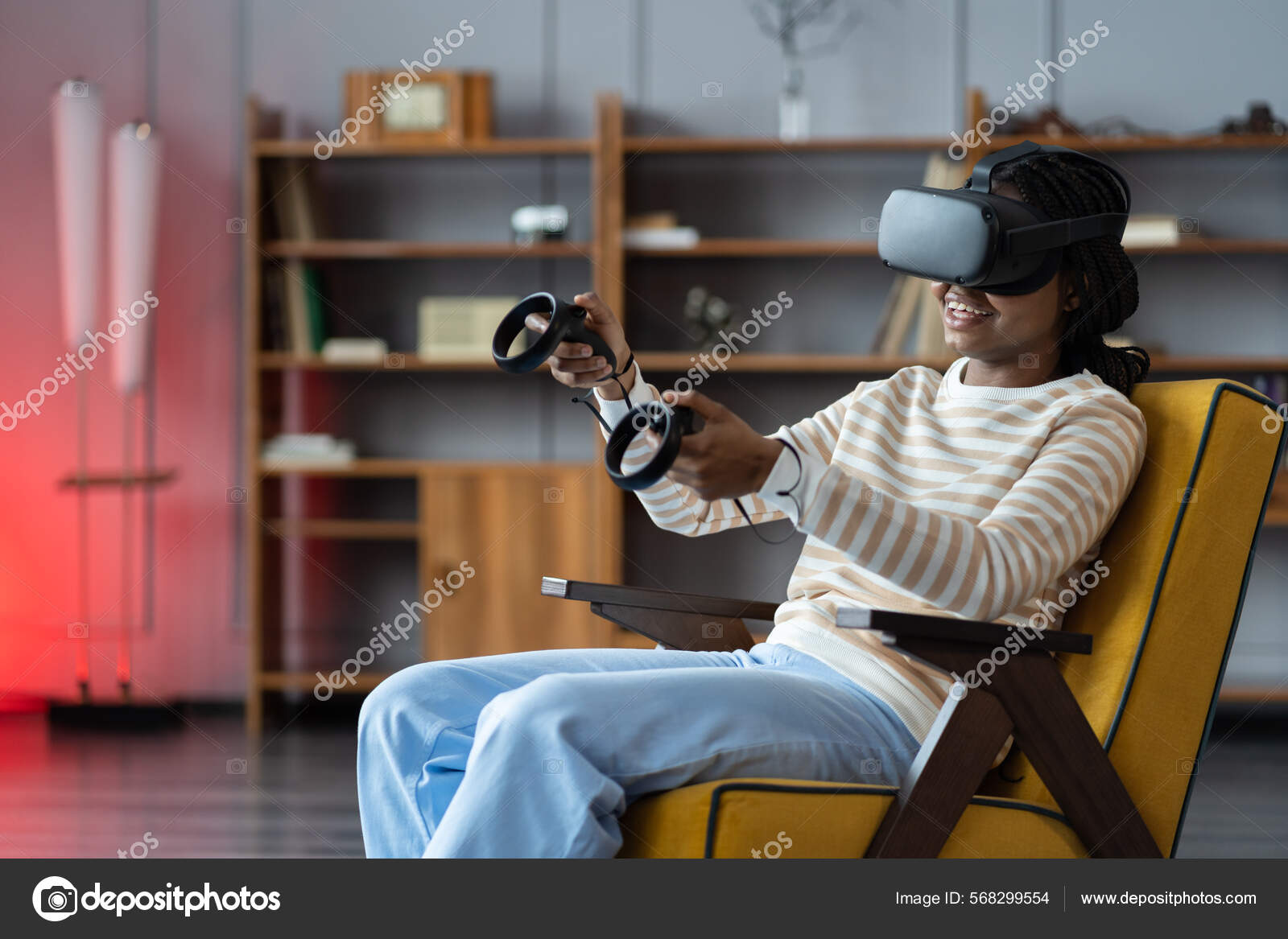 Happy young african american woman wearing virtual reality goggles