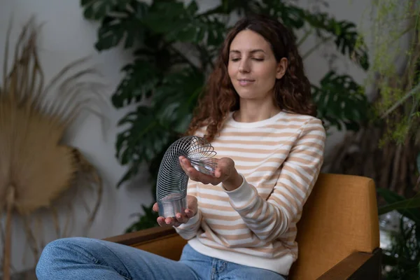 Relaxed Calm Woman Playing Spring Toy Stress Relief Sit Crossed — 图库照片