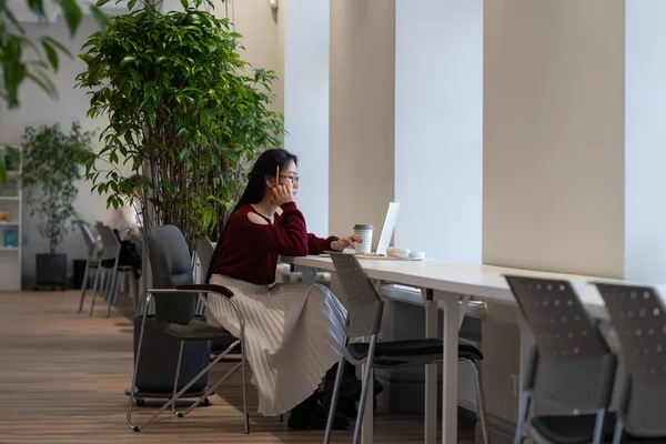Pensive Asian Young Woman Looking Thoughtfully Laptop Screen While Working — Fotografia de Stock