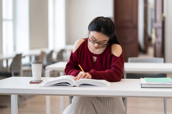 Smart Asian Girl Reading Textbook Taking Notes Writing Outline While — Stockfoto