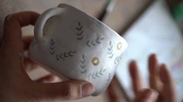 Person Paints Brown Circles Pattern White Ceramic Mug Sitting Kitchen — Video Stock