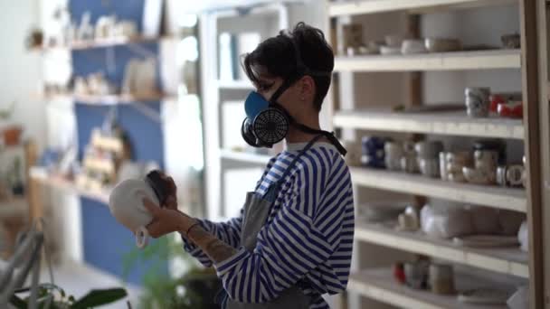 Young Woman Potter Wearing Respirator Sanding Ceramics Sandpaper Grinding Block — Stock Video