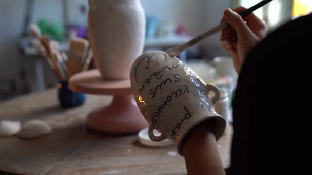 Young Craftswoman Paints Handmade Vase Using Professional Equipment Sitting Table — Video Stock